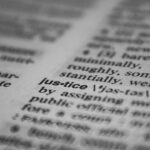 Selective focus close-up of the word justice in a dictionary, emphasizing concept clarity.