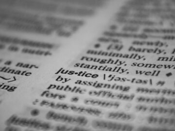 Selective focus close-up of the word justice in a dictionary, emphasizing concept clarity.