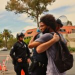 A police officer and protester share a hug during a peaceful protest in Los Angeles.