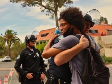 A police officer and protester share a hug during a peaceful protest in Los Angeles.