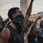 A powerful demonstration in Rio de Janeiro with protesters passionately raising their fists in unity.