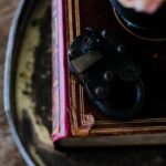 Aged book with vintage lock on a rustic tray, offering a mysterious vibe.