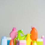 Assorted colorful plastic cleaning bottles on a white background.