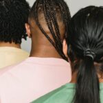 Three men showcasing modern hairstyles with a focus on individuality and unity.