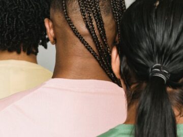 Three men showcasing modern hairstyles with a focus on individuality and unity.
