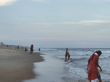 People enjoying a calm evening walk on Chennai's picturesque beachfront.