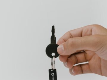 Close-up of a hand holding a key and USB with copyspace.