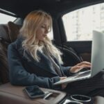Businesswoman working remotely on a laptop in the backseat of a luxury car. Stylish, modern, and focused.