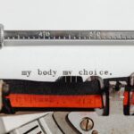 Close-up of a vintage typewriter typing 'my body my choice.'