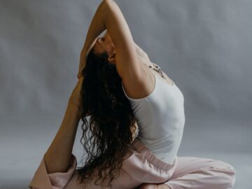 Woman practicing yoga in a serene studio setting, showcasing flexibility and wellness.