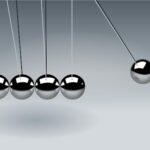 Dynamic illustration of Newton's Cradle showing motion and reflection concepts in physics.