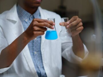 Focused young scientist mixing chemicals during an experiment in a laboratory.