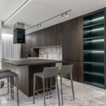 Modern interior design of contemporary spacious kitchen with dining zone and wooden furniture in apartment