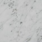 Vertical close-up showcasing white marble's natural texture and patterns.