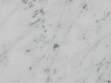Vertical close-up showcasing white marble's natural texture and patterns.