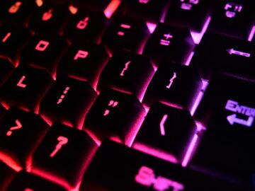 Vibrant close-up of a modern RGB backlit mechanical keyboard with glowing keys.