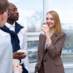 Business colleagues interacting during a coffee break in an office setting, fostering connection and teamwork.