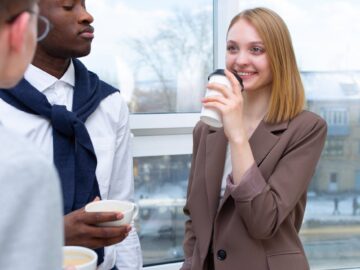 Business colleagues interacting during a coffee break in an office setting, fostering connection and teamwork.