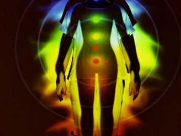 Human silhouette with vibrant chakra energy projection, symbolizing balance and spirituality.