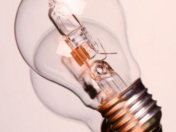 Detailed image of a classic clear incandescent bulb, encapsulating energy and innovation concepts.