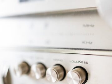 Creative design of audio stereo power amplifier with rows of knobs under volume meters with indicators