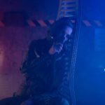 A person in a futuristic setting with an oxygen mask and dramatic neon lighting.