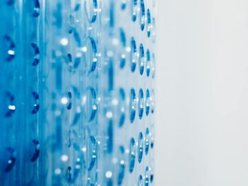 Close-up of an abstract blue surface featuring circular indentations creating a modern pattern.