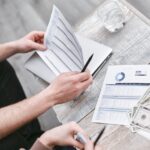 Two professionals reviewing financial documents with charts, fostering collaboration.