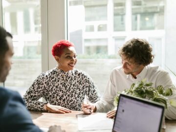 Casual business meeting with diverse professionals discussing a project.