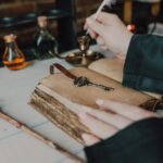 Mystical setup with a quill, spell book, and magical potions.