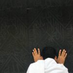 A pilgrim deep in prayer at the Kaaba in Makkah, symbolizing faith and devotion.