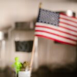 Close-up of cannabis buds with an American flag in the background, highlighting US legalization.