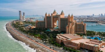 A breathtaking drone shot of Atlantis, The Palm resort in Dubai, highlighting the luxurious urban landscape.