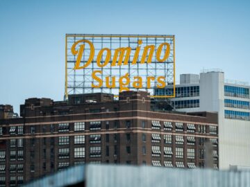 Iconic Domino Sugars sign atop a brown industrial building in Baltimore, Maryland.