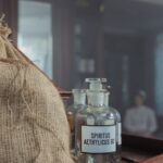 Elegant vintage glass bottle labeled Spiritus Aethylicus in a classic setting.