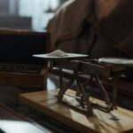 Classic vintage weighing scale with a small heap of white powder placed indoors on a wooden surface.