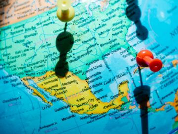 Detailed map of North America featuring pushpins highlighting regions in Mexico and the US.