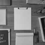 Top view of a desk with voting-themed items, including a notepad with 'Left or Right?' and scattered letters spelling 'Vote'.