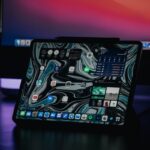 A modern tablet showcasing an abstract interface in a dimly lit environment, highlighting technology.