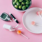 Contrasting health choices with Brussels sprouts and lollipops on a pink background.