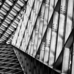 Black and white abstract view of industrial steel trusses in modern architecture.