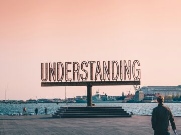 white and black boat on sea dock during daytime