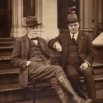 man in black suit sitting on stairs