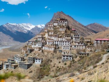 a very tall building sitting on top of a hill