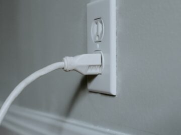 white usb cable plugged in white electric socket